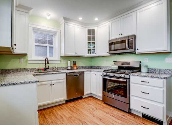 Lancaster City kitchen remodel with white cabinets and green walls