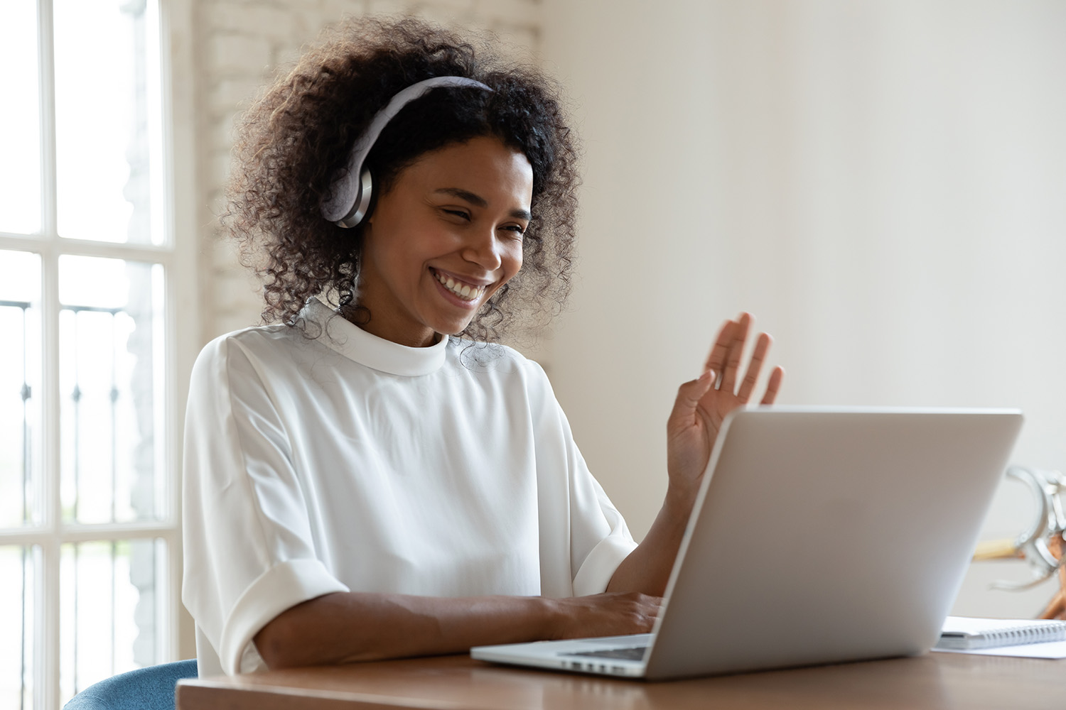Woman smiling during virtual meeting about remodeling project