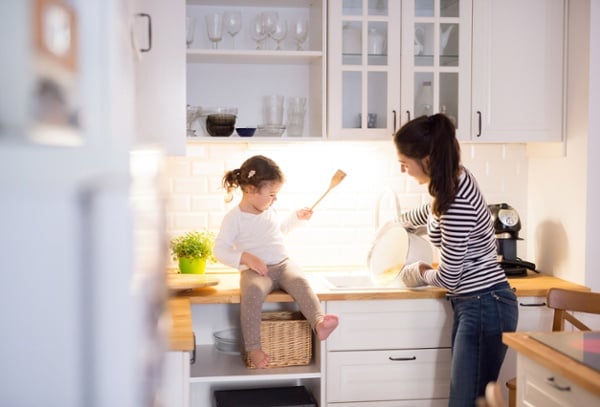 Mother and Daughter in kitchen with white cabinets