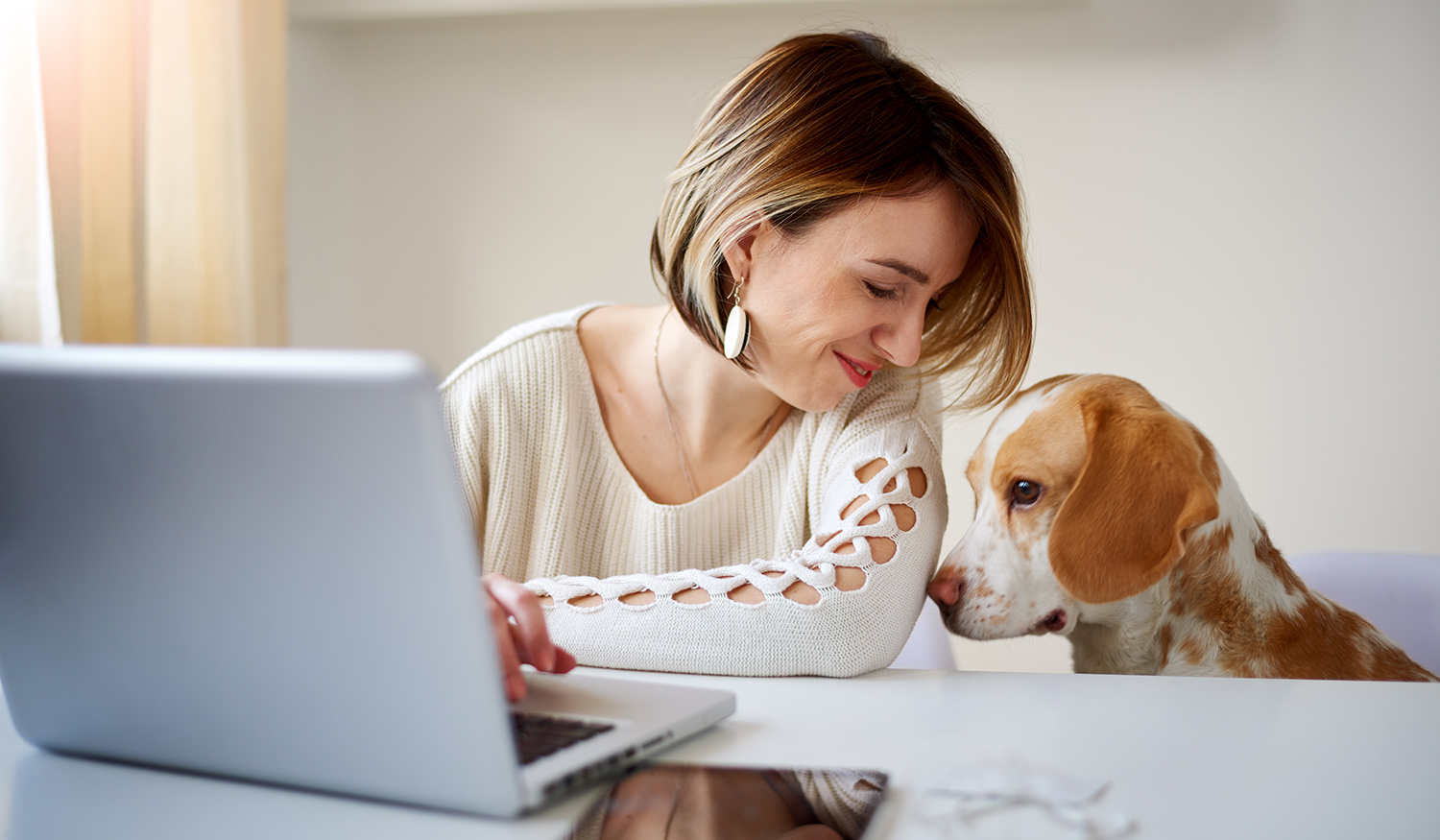 Woman and dog looking at computer