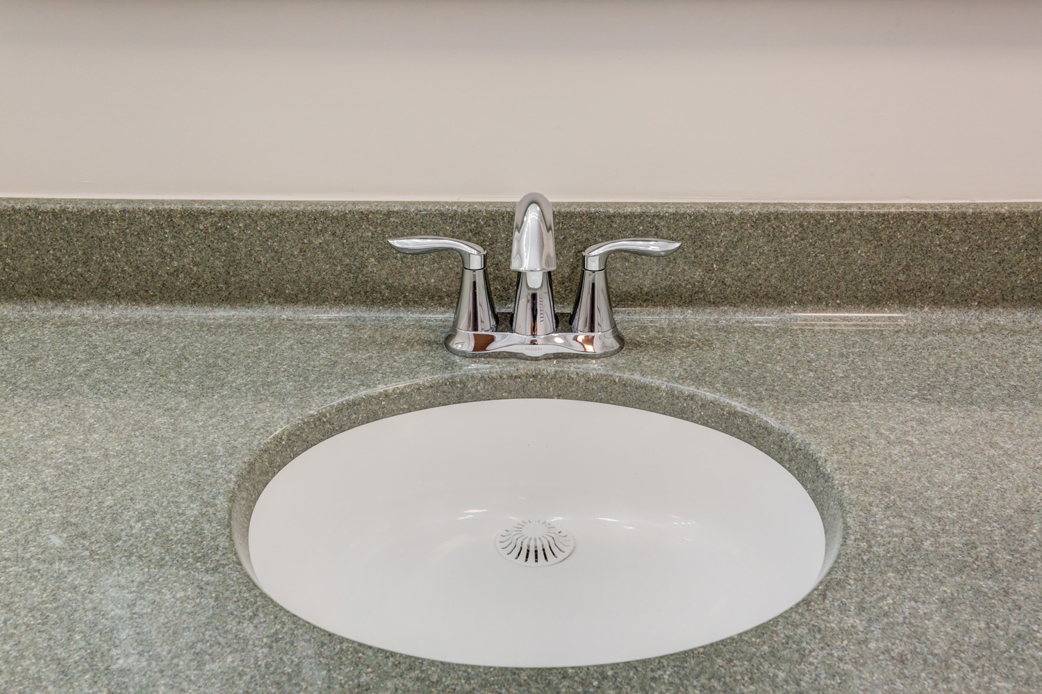 Single sink with chrome faucet in Bloomingdale guest bathroom remodel